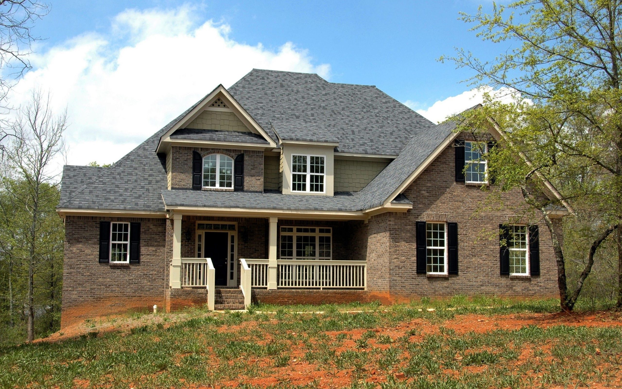 Two-story brick home exterior with covered front porch