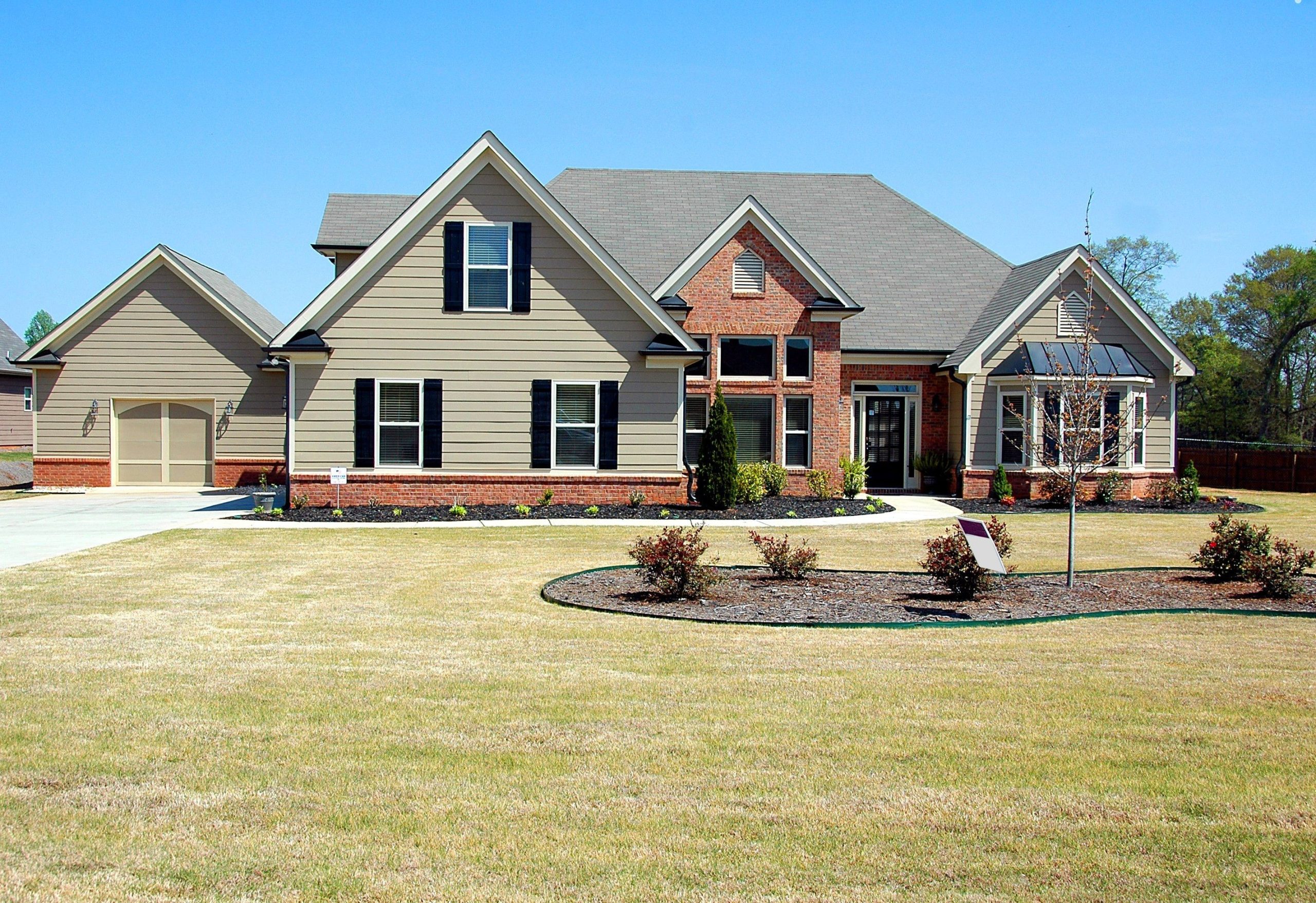 Brick and siding two-story home with landscaped front yard